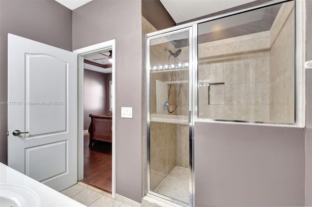 full bath featuring a stall shower, tile patterned flooring, and a sink