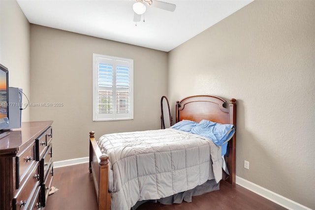 bedroom with a ceiling fan, dark wood finished floors, and baseboards