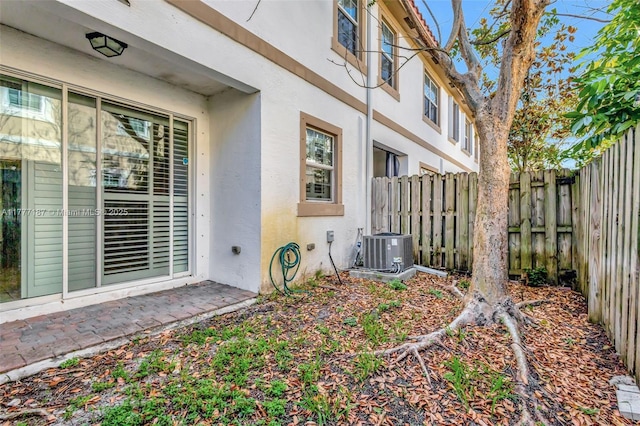 exterior space featuring fence and cooling unit