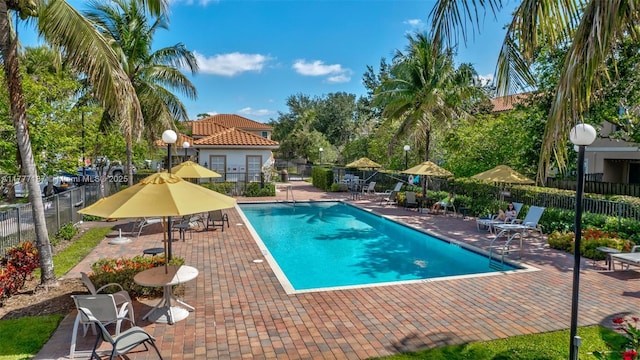 pool with fence and a patio area