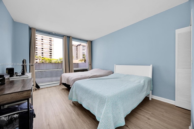 bedroom featuring baseboards and wood finished floors