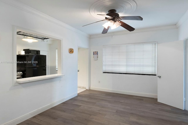 unfurnished living room with ornamental molding, a ceiling fan, wood finished floors, and baseboards