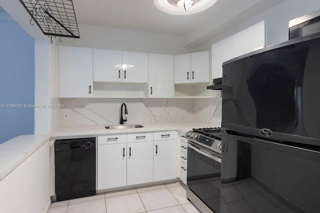 kitchen with white cabinets, black appliances, decorative backsplash, and a sink