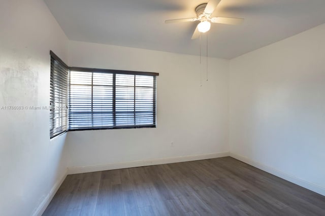 empty room with baseboards, wood finished floors, and ceiling fan