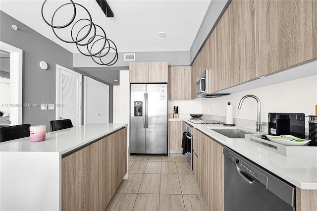 3900 Biscayne Blvd Unit S-920, Miami, FL 33137 - kitchen featuring stainless steel appliances, modern cabinets, a sink, and light brown cabinetry
