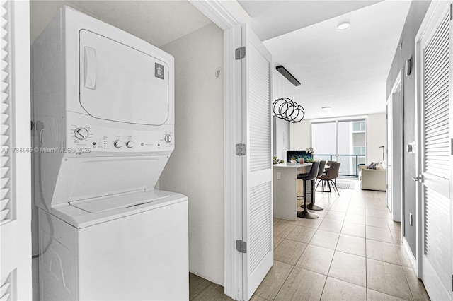 3900 Biscayne Blvd Unit S-920, Miami, FL 33137 - laundry area with stacked washer and clothes dryer and light tile patterned flooring