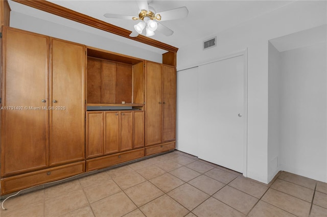 733 NW 30th Ct Unit 1, Wilton Manors, FL 33311 - unfurnished bedroom featuring light tile patterned flooring, a closet, and ceiling fan