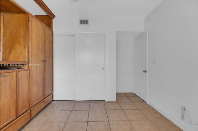 733 NW 30th Ct Unit 1, Wilton Manors, FL 33311 - unfurnished bedroom featuring light tile patterned floors and a closet
