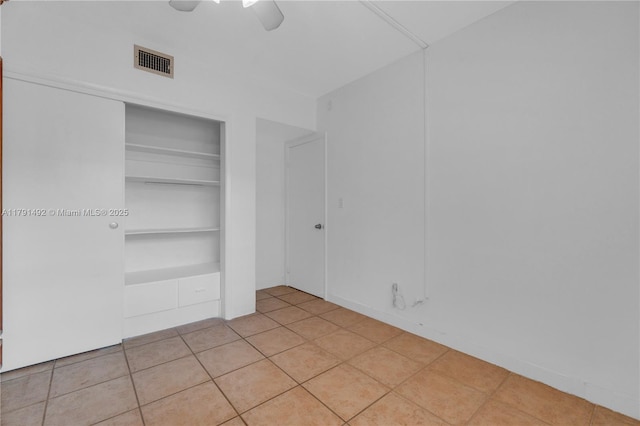 733 NW 30th Ct Unit 1, Wilton Manors, FL 33311 - unfurnished bedroom with a closet, light tile patterned floors, and ceiling fan