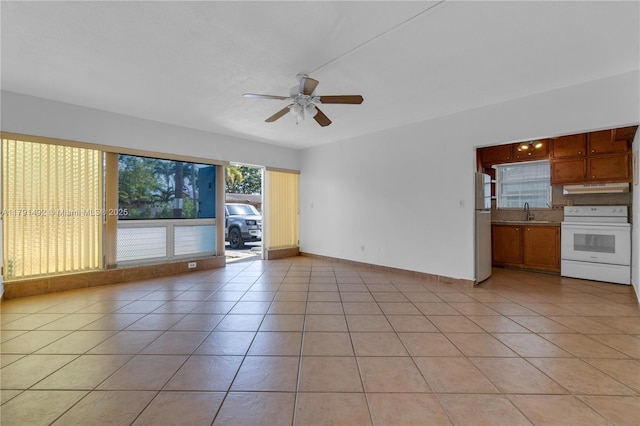 733 NW 30th Ct Unit 1, Wilton Manors, FL 33311 - unfurnished living room with a ceiling fan and light tile patterned floors