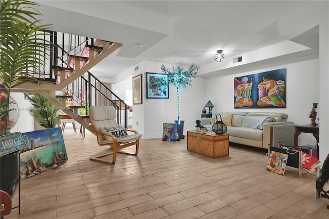 1131 SW 104th Ct, Miami, FL 33174 - living room featuring stairs, visible vents, wood finished floors, and a textured ceiling