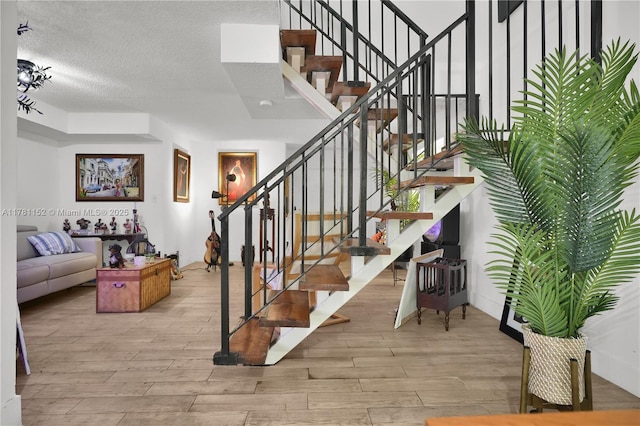 1131 SW 104th Ct, Miami, FL 33174 - stairs featuring a textured ceiling and wood finished floors