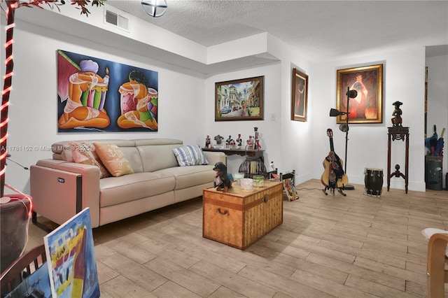 1131 SW 104th Ct, Miami, FL 33174 - living room featuring a textured ceiling, visible vents, and light wood-style flooring