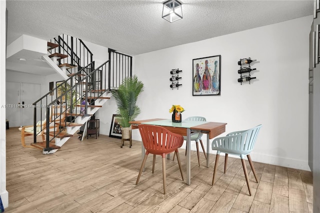 1131 SW 104th Ct, Miami, FL 33174 - dining area with a textured ceiling, wood finished floors, stairway, and baseboards
