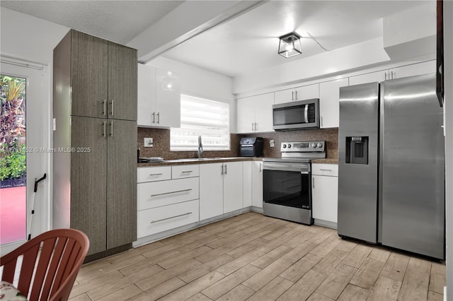 1131 SW 104th Ct, Miami, FL 33174 - kitchen featuring light wood-type flooring, stainless steel appliances, and plenty of natural light
