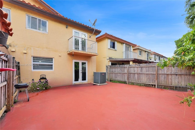 1131 SW 104th Ct, Miami, FL 33174 - back of house with stucco siding, fence, central AC, french doors, and a balcony