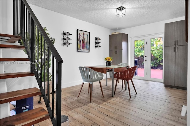 1131 SW 104th Ct, Miami, FL 33174 - dining space with light wood-style floors, stairway, a textured ceiling, and baseboards