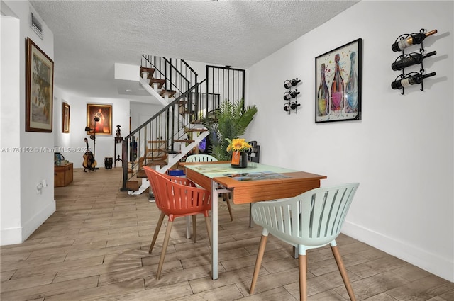 1131 SW 104th Ct, Miami, FL 33174 - dining space with baseboards, stairway, wood finished floors, and a textured ceiling