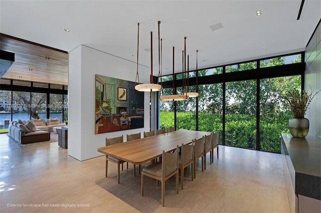 dining room with a high ceiling and expansive windows