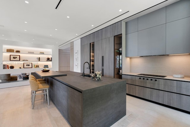 kitchen with dark countertops, modern cabinets, gray cabinets, and light wood-type flooring