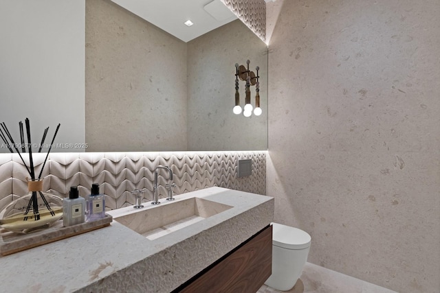 bathroom featuring toilet and vanity