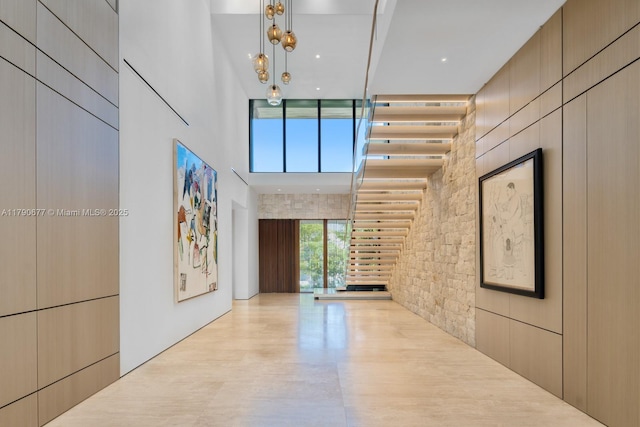 interior space featuring stairway and a high ceiling