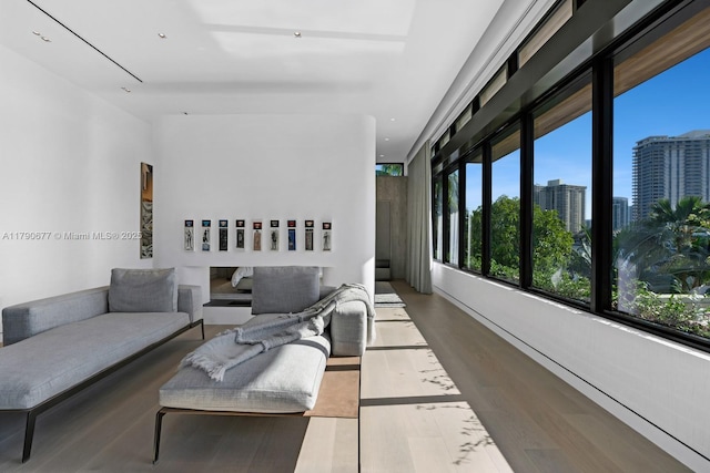 living area with a city view and wood finished floors