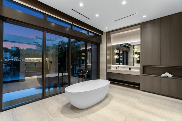full bath featuring vanity and a freestanding tub