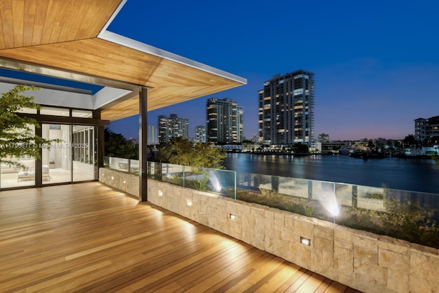 unfurnished sunroom featuring a water view and a city view