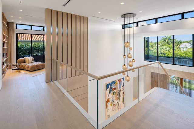 194 S Island Dr, Golden Beach, FL 33160 - corridor featuring wood finished floors, an upstairs landing, healthy amount of natural light, and recessed lighting