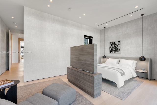 bedroom with recessed lighting and light wood finished floors