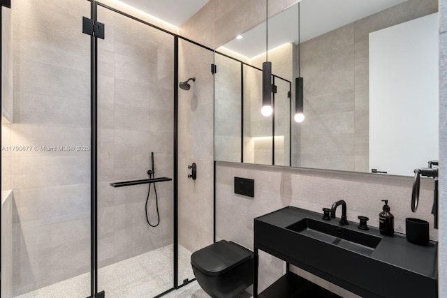 full bathroom with vanity, tile walls, a shower stall, and toilet