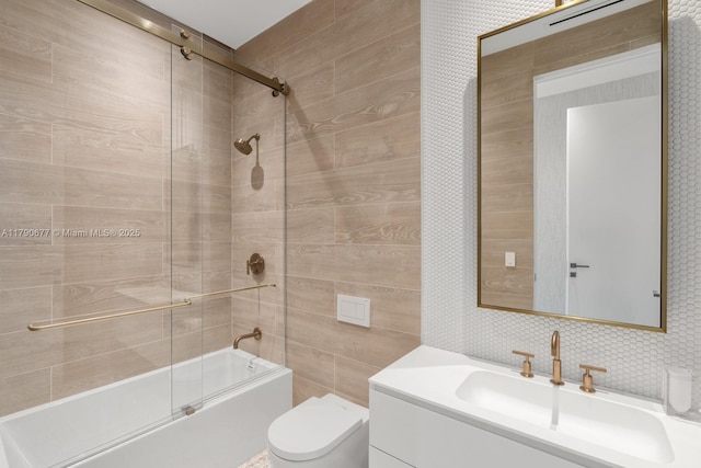 full bath with vanity, toilet, enclosed tub / shower combo, tile walls, and decorative backsplash