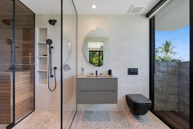 bathroom featuring walk in shower, tile walls, speckled floor, and visible vents