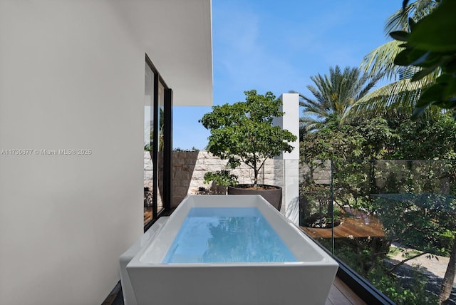 view of pool featuring a hot tub