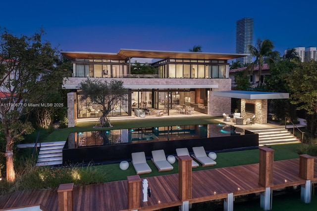 rear view of property with a patio and an outdoor pool