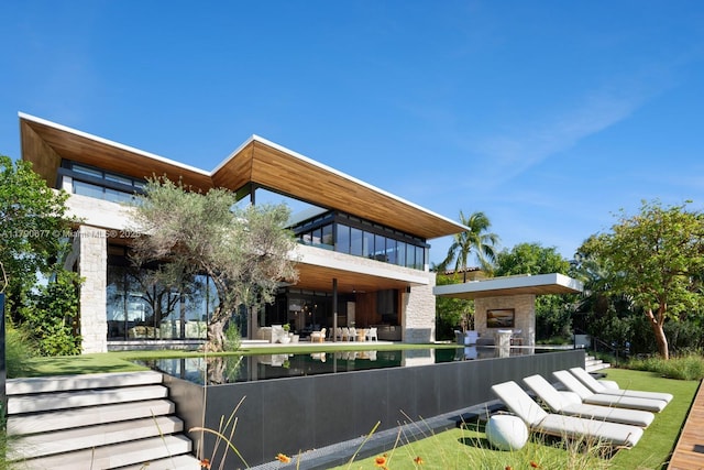 194 S Island Dr, Golden Beach, FL 33160 - back of house with stone siding