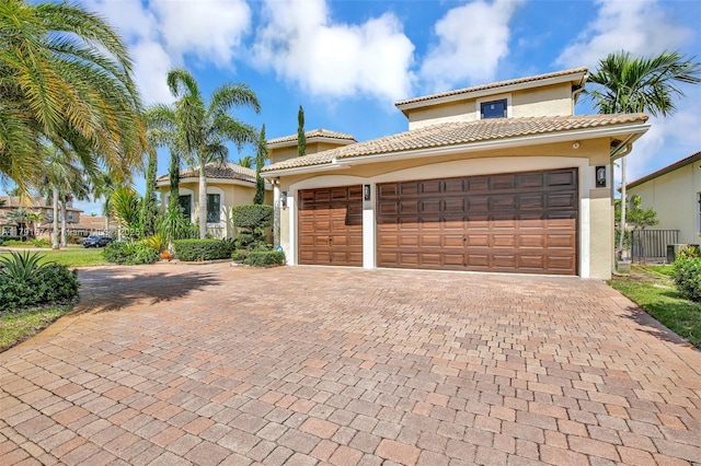 3260 SW 189th Ave, Miramar, FL 33029 - mediterranean / spanish-style house featuring stucco siding, an attached garage, a tile roof, and decorative driveway