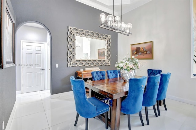 3260 SW 189th Ave, Miramar, FL 33029 - tiled dining area with baseboards, arched walkways, a chandelier, and ornamental molding