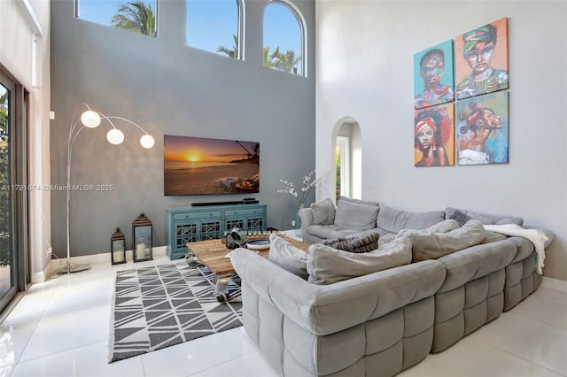 3260 SW 189th Ave, Miramar, FL 33029 - tiled living room featuring arched walkways and a towering ceiling