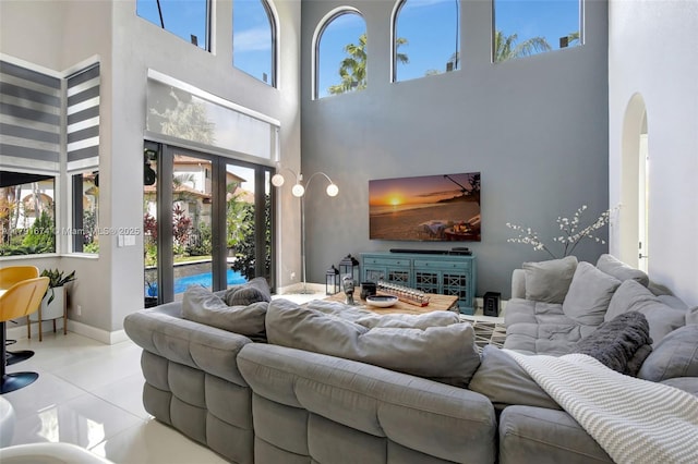 3260 SW 189th Ave, Miramar, FL 33029 - living room with tile patterned flooring, arched walkways, baseboards, and a high ceiling