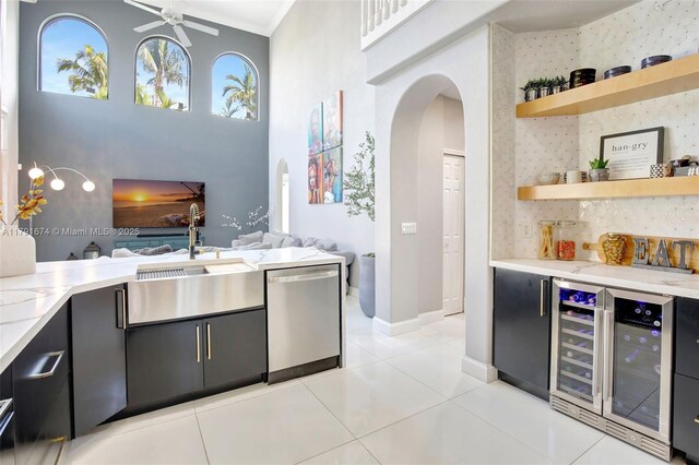 3260 SW 189th Ave, Miramar, FL 33029 - bar featuring a sink, a towering ceiling, beverage cooler, arched walkways, and dishwasher
