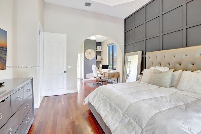 3260 SW 189th Ave, Miramar, FL 33029 - bedroom featuring a high ceiling, arched walkways, baseboards, visible vents, and dark wood-style floors