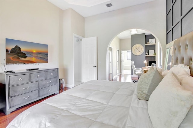 3260 SW 189th Ave, Miramar, FL 33029 - bedroom with a high ceiling, arched walkways, baseboards, wood finished floors, and visible vents