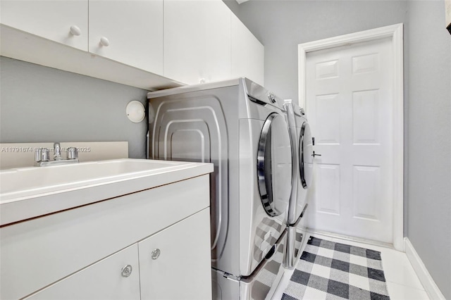 3260 SW 189th Ave, Miramar, FL 33029 - washroom featuring baseboards, cabinet space, and independent washer and dryer