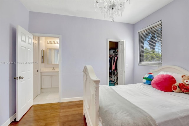 3260 SW 189th Ave, Miramar, FL 33029 - bedroom with an inviting chandelier, a sink, baseboards, wood finished floors, and a closet