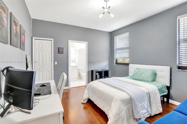 3260 SW 189th Ave, Miramar, FL 33029 - bedroom featuring baseboards, connected bathroom, wood finished floors, and multiple windows