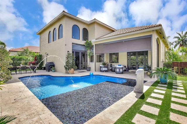 3260 SW 189th Ave, Miramar, FL 33029 - rear view of house with stucco siding, french doors, an outdoor hangout area, a fenced in pool, and a patio area