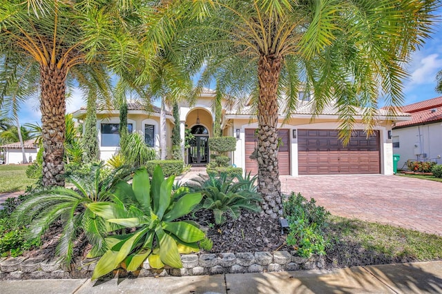 3260 SW 189th Ave, Miramar, FL 33029 - mediterranean / spanish-style home featuring stucco siding, an attached garage, and decorative driveway
