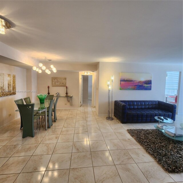 dining room with a chandelier and light tile patterned floors